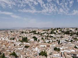 Panoramic view of the city of Granada in Spain. Old and multicultural town. Sunny day, blue sky and some clouds. Heritage Spain.