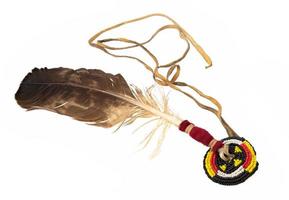 Eagle feather beaded as Indian hair accessory isolated on white photo