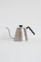 Metal goose neck kettle isolated on white background photo