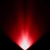 abstract light red spotlight warm ray light effect overlay realistic falling snowflakes pattern on black. photo