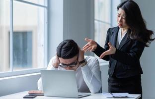 Two Asian colleagues are having a heated argument with each other photo