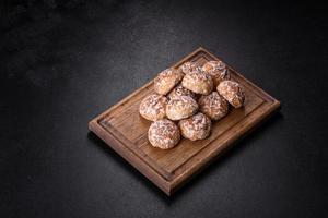 Tasty homemade gingerbread cookies on dark concrete table photo