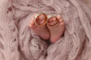 Small beautiful legs of a newborn baby in the first days of life photo