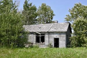 an old abandoned school house held together with a rope through a window photo