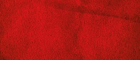 Red suede background. Natural leather macro photo of bright red color.