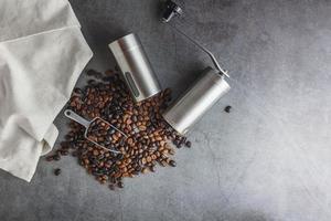 Hand coffee grinder and coffee beans on the table photo