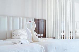 Sharm-El-Sheikh, Egypt, 2022-Heart shape swan towels in hotel room photo
