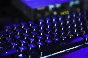 PC Keyboard with glowing blue light background photo