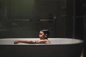 Asian boy bathing on the bathub photo