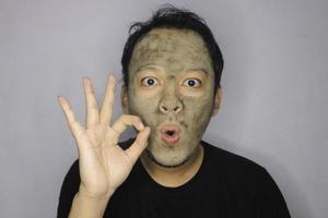 Wow Asian Man was shock and look at the camera when he use beauty face mask photo