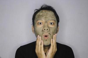 Wow Asian Man was shock and look at the camera when he use beauty face mask photo