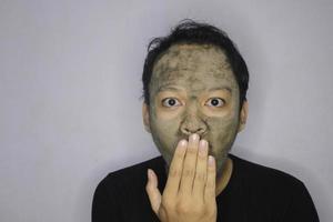 Wow Asian Man was shock and look at the camera when he use beauty face mask photo