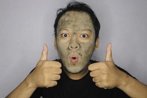 Wow Asian Man was shock and look at the camera when he use beauty face mask photo