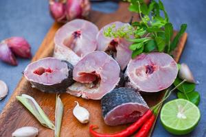 Fresh raw Snake head fish menu freshwater fish, Snakehead fish for cooking food, striped snakehead fish chopped with ingredients herb and spices on wooden cutting board and table kitchen background photo