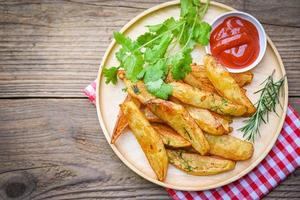 Mediabakery - Photo by Radius Images - Seasoned French Fries in Paper Bag  with Wooden Fork and Ketchup Studio Shot