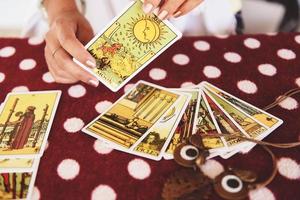 Tarot cards reading divination Psychic readings and clairvoyance concept fortune teller hands , and Horoscopes photo