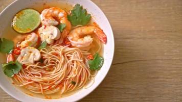 noodles with spicy soup and shrimps in white bowl - Asian food style