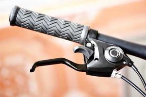 Bicycle handlebars and bike hand pushing brake lever photo