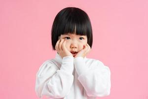 lovely baby girl portrait, isolated on pink background photo