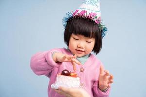 lovely baby girl portrait, isolated on blue background photo