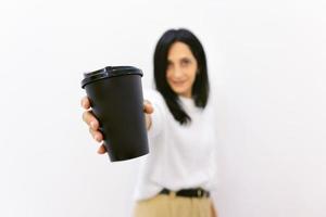 person gives cup of coffee photo