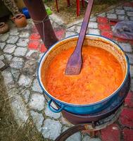 Aivars in preparation in giant pot on fire photo