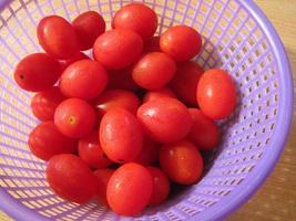 Cherry tomatoes with dew drops in sunlight. photo