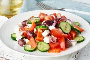 Greek village salad horiatiki with feta cheese, olives, cherry tomato, cucumber and red onion photo