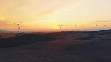 Aerial view five wind turbines standing in open field with beautiful sky backgrounds panorama. Copy paste renewable energy concept background video