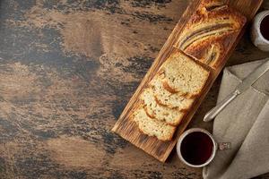 Banana bread. Cake with banana, traditional american cuisine. Slices of loaf. Dark background
