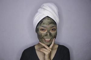 Smile Asian women smiling when she use beauty face mask photo