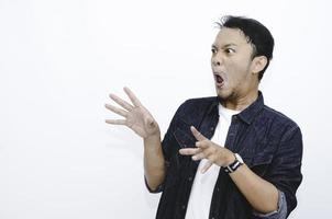 Young asian man is surprised and shouting wow with pointing right with his hand isolated on gray background. photo