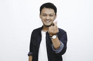 Young Asian Man showing love Korean sign with isolated white background. photo