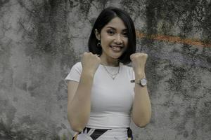 happy and winner Asian beautiful girl with white shirt photo