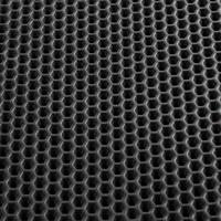 Texture of black leather background with honeycomb shape pattern, macro photo