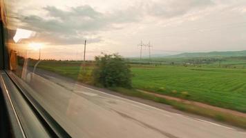 vista della finestra sul paesaggio naturale sul tramonto in movimento dal bus in movimento. giro turistico e viaggi. vacanze in campagna caucaso. campagna georgiana video