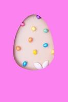 Easter egg cut out of paper and bunny ears with eggs. Easter holiday concept vertical format with copy space photo