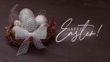 Happy Easter nest with eggs on a brown background. Template Happy Easter greeting card with creative easter eggs and copy space photo