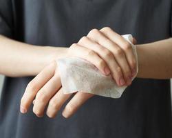 Woman wash hand wet wipes, to prevent illness Novel coronavirus 2019-nCoV after public place photo