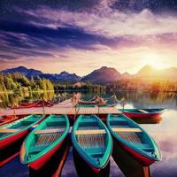 Boat on the dock surrounded mountains, starry sky . Fantastic Sh photo