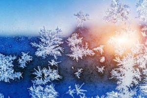 Frosty natural pattern on winter window photo