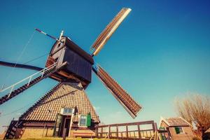 Old Dutch windmills spring from the canal in Rotterdam. Holland. photo