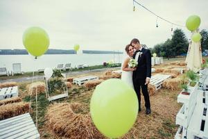 beautiful young wedding couple kissing , blonde bride with flowe photo