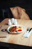 Steak with crispy golden fries and tomato spicy sauce photo