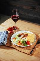 Caesar salad with croutons, quail eggs, cherry tomatoes and gril photo