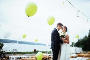 Beautiful young couple kissing wedding, blonde bride with her gr photo