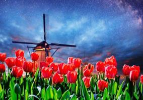 Traditional Dutch windmills from the canal in Rotterdam photo