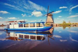 Traditional Dutch windmills from the channel Rotterdam. Boat tha photo