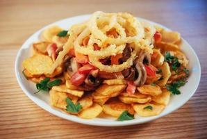 salad with fried potatoes, mushrooms and tomatoes