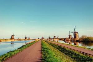 The road leading to the Dutch windmills from the canal photo